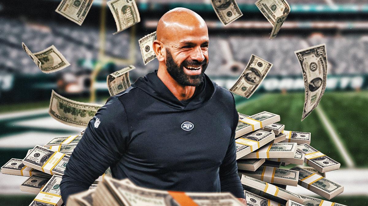 Robert Saleh surrounded by piles of cash.