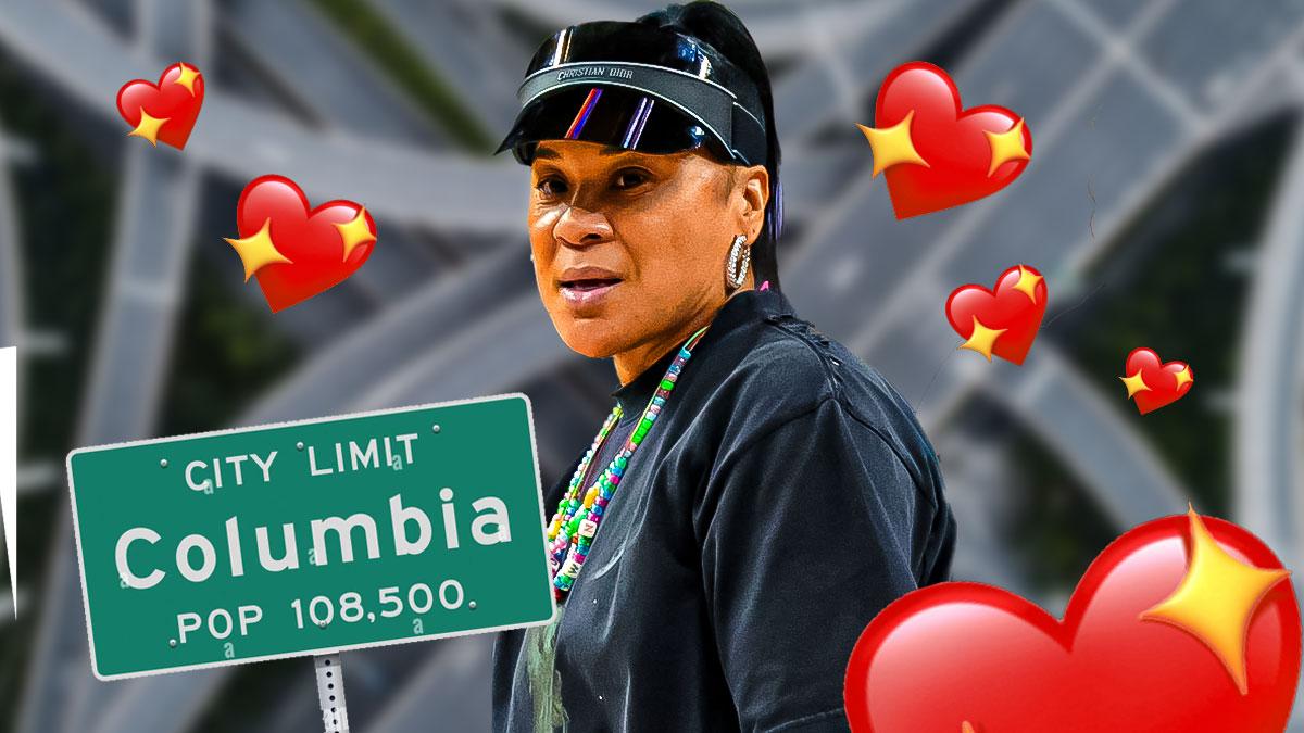 South Carolina women's basketball coach Dawn Staley in front of an interstate highway leading into Columbia, South Carolina, United States, with a Columbia city limits sign and a bunch of hearts