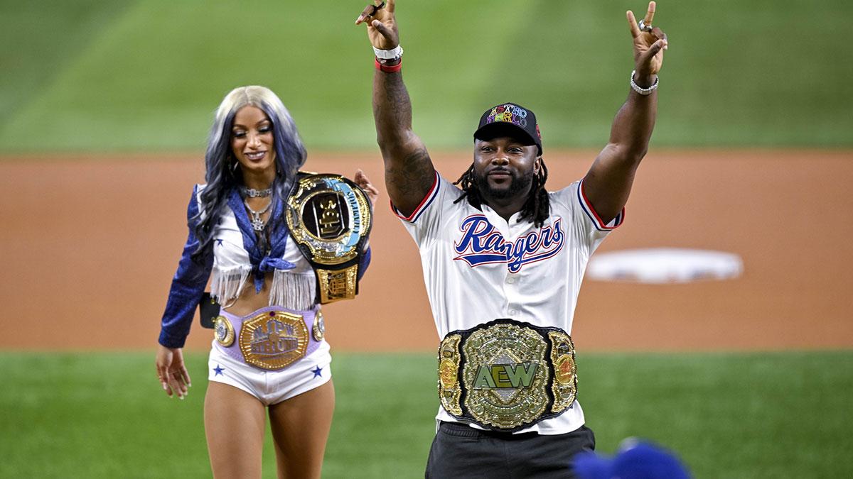 Professional wrestler Stephon Swerve Strickland throws out the first pitch as actress and professional wrestler Mercedes Mone Varnado looks on before the game between the Texas Rangers and the Minnesota Twins at Globe Life Field.