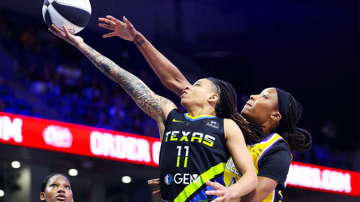 Dallas Wings guard JJ Quinerly (11) drives to the basket as Los Angeles Sparks forward Liatu King (4) defends during the second half at College Park Center.