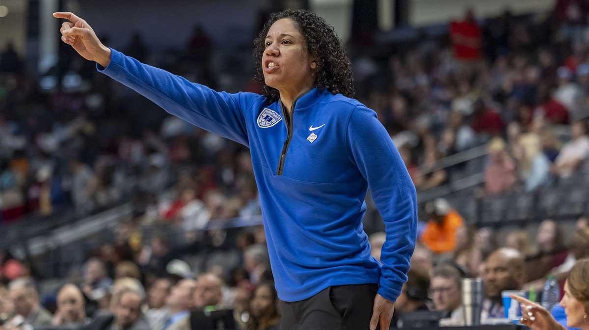 Duke Blue Devils head coach Kara Lawson signals to her team during the Sweet 16 NCAA Tournament basketball game against the North Carolina Tar Heelsat Legacy Arena.