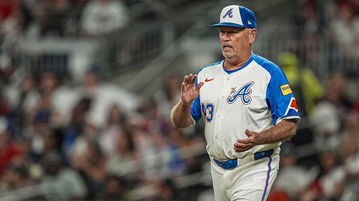 Atlanta Braves manager Brian Snitker (43) walks to the mound to change pitchers against the New York Mets during the seventh inning at Truist Park.