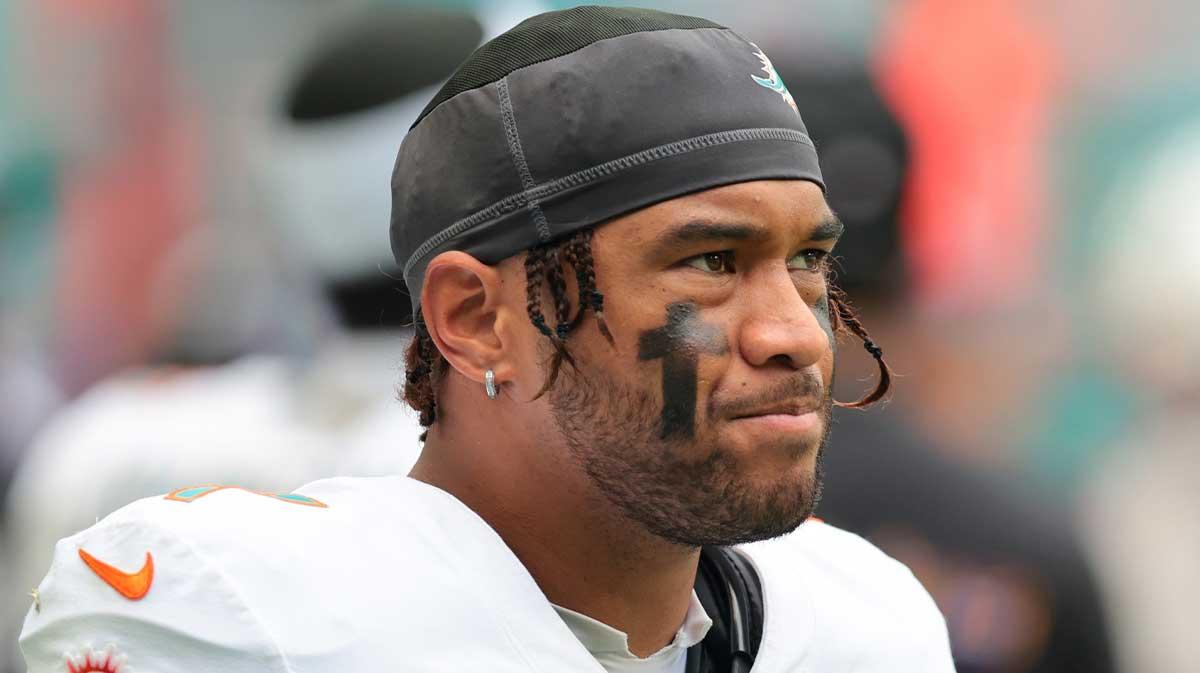 Miami Dolphins quarterback Tua Tagovailoa (1) looks on from thevbench against the Los Angeles Chargers during the fourth quarter at Hard Rock Stadium.