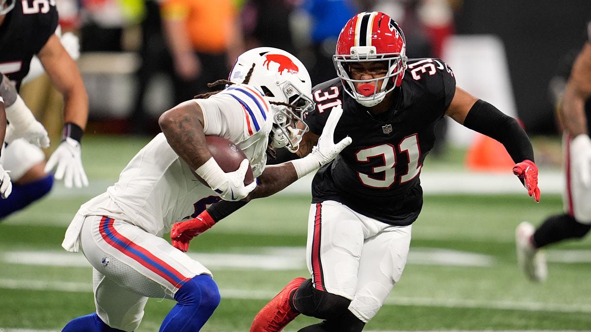 Buffalo Bills running back James Cook (4) takes on Atlanta Falcons safety Xavier Watts (31) during the first half of a game at Mercedes-Benz Stadium.