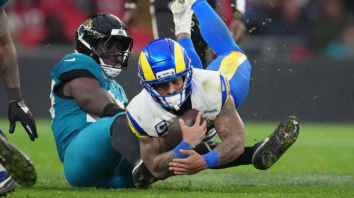 Jacksonville Jaguars linebacker Foye Oluokun (23) tackles Los Angeles Rams running back Kyren Williams (23) during the second half of an NFL International Series game at Wembley Stadium.
