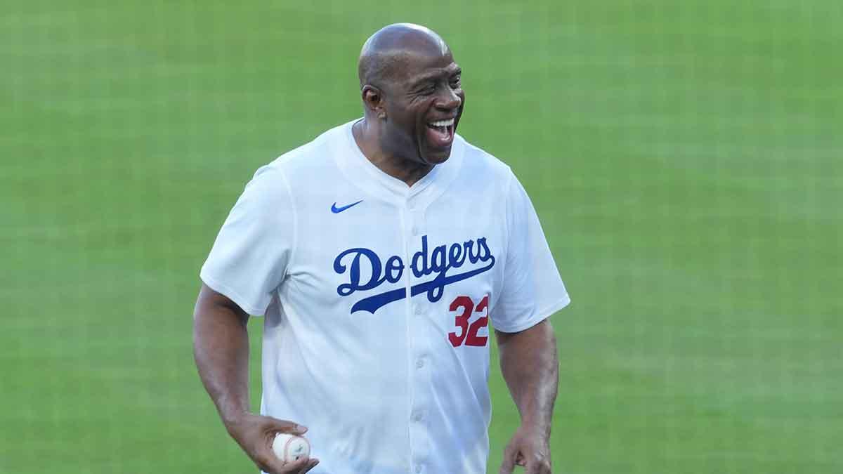 Los Angeles Dodgers co owner Magic Johnson reacts before throwing the ceremonial first pitch before game five of the 2025 MLB World Series between the Toronto Blue Jays and the Los Angeles Dodgers at Dodger Stadium.