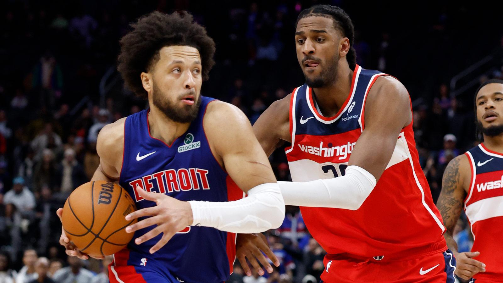 Detroit Pistons guard Cade Cunningham (2) dribbles defended by Washington Wizards center Alex Sarr (20) in overtime at Little Caesars Arena.