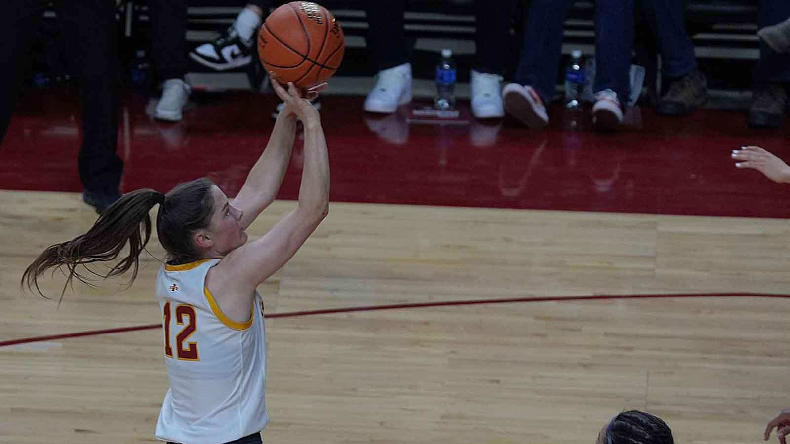 Iowa State Cyclones' guard Kenzie Hare takes a three-point shot around Iowa Hawkeyes guard Taylor McCabe during the second quarter in the NCAA women’s basketball Cy-Hawk Series on Dec. 10, 2025, at Hilton Coliseum in Ames, Iowa.