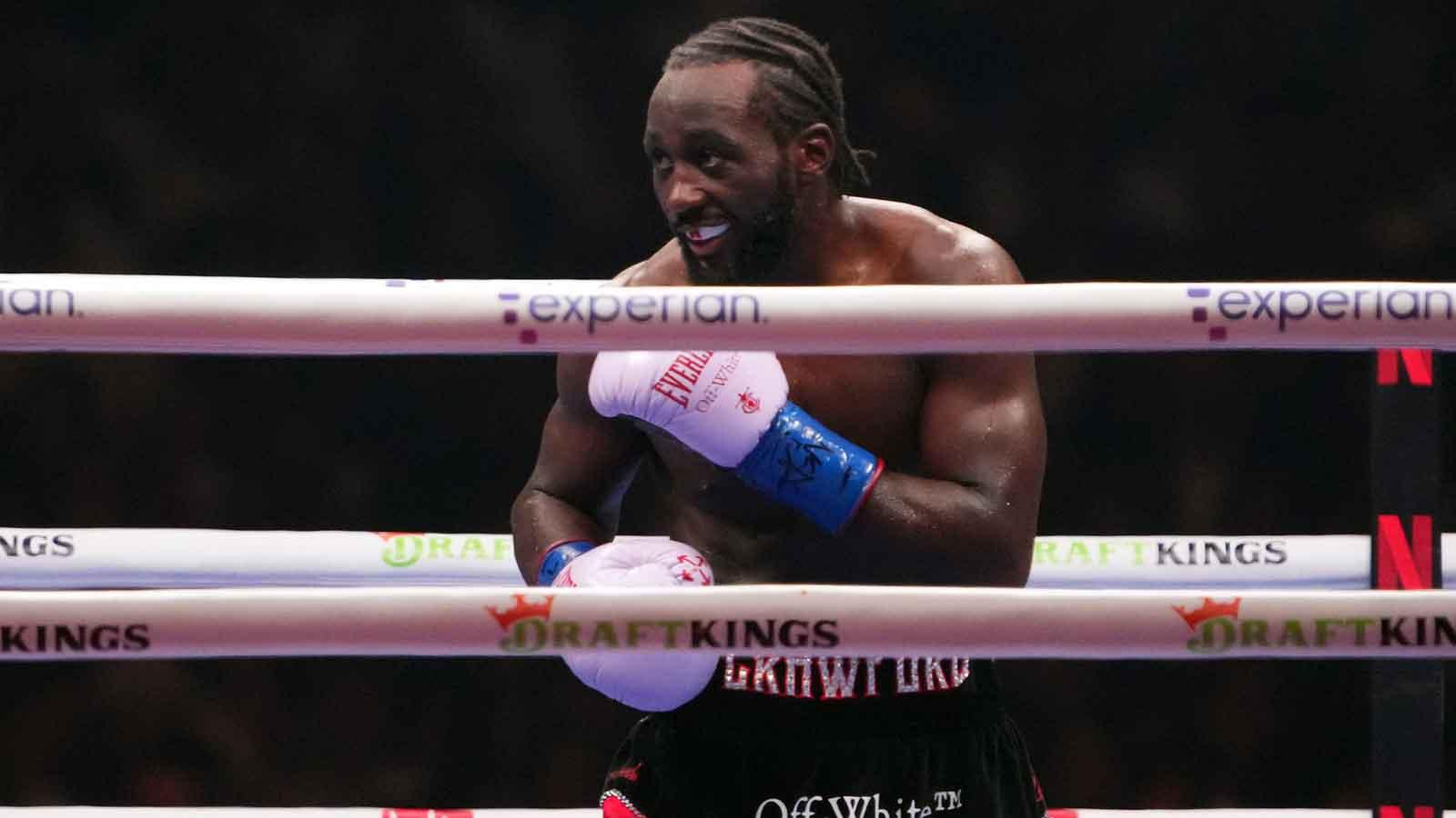 Canelo Alvarez (black/gold trunks) and Terence Crawford (black/red trunks) box during their super middleweight title bout at Allegiant Stadium.