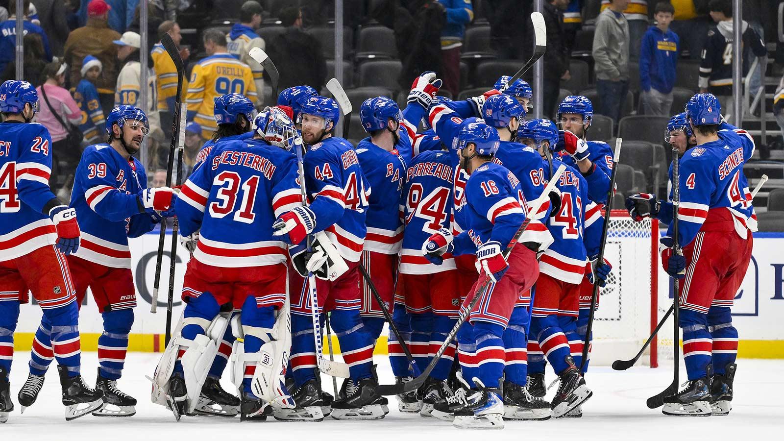 New York Rangers celebrate after they defeated the St. Louis Blues during overtime at Enterprise Center.