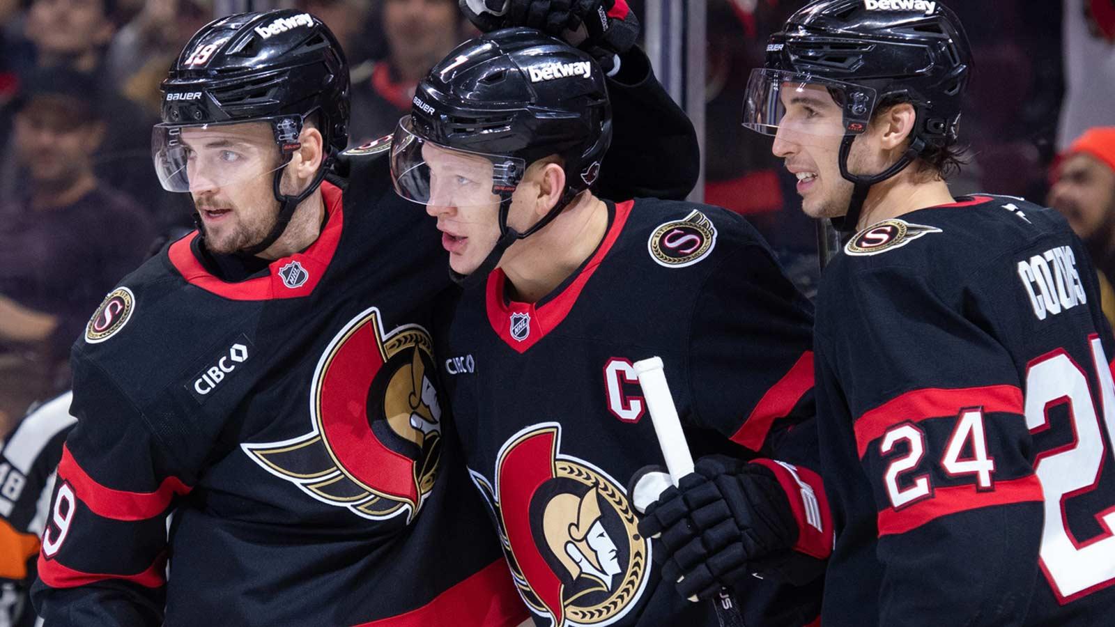 Ottawa Senators right wing Drake Batherson (19-left) and center Dylan Cozens (24-right) celebrate a goal scored by left wing Brady Tkachuk (7-center) in the first period against the Pittsburgh Penguins at the Canadian Tire Centre.