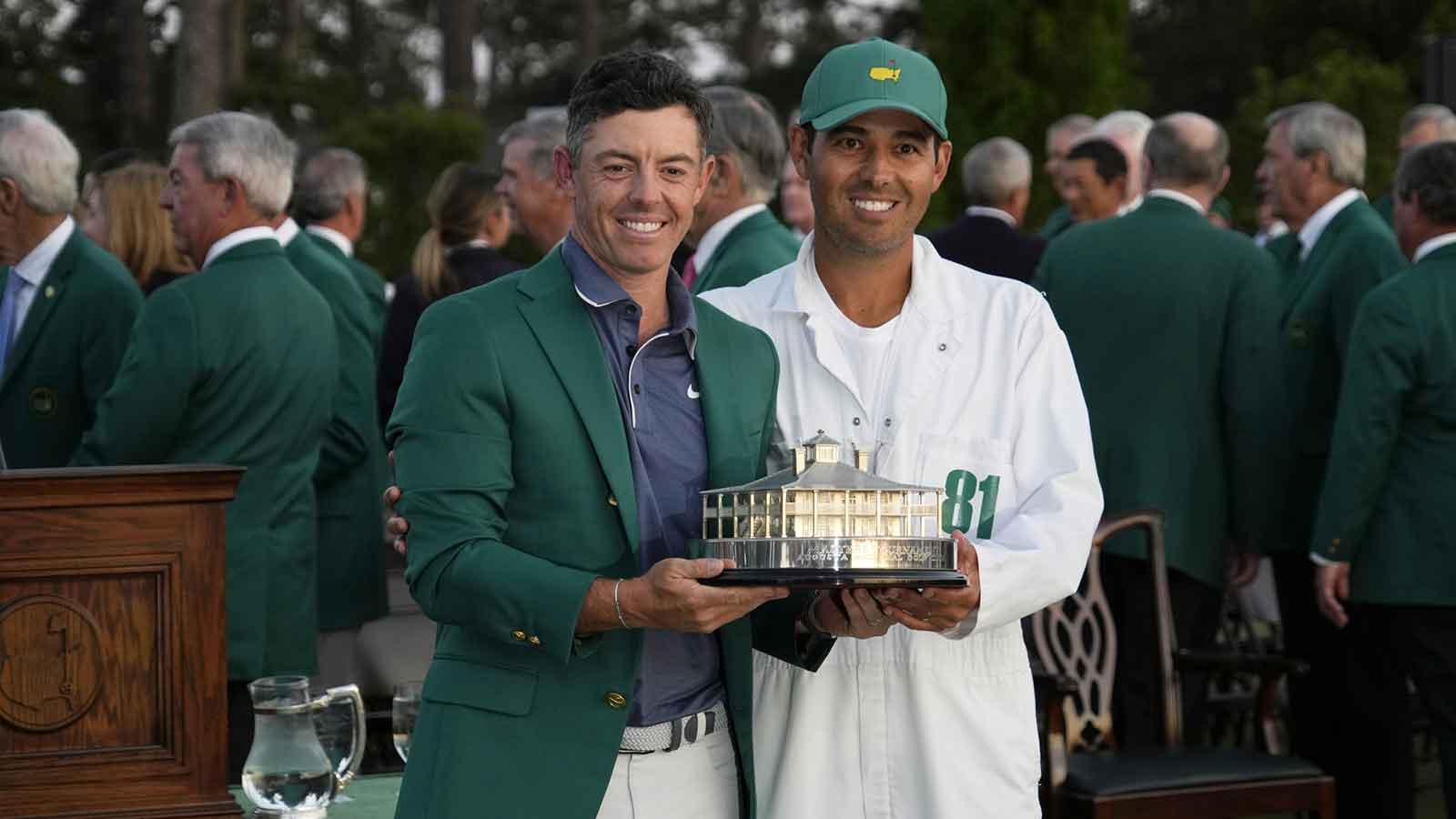 Rory McIlroy and his caddie Harry Diamond celebrate with the trophy after winning the Masters Tournament at Augusta National Golf Club.