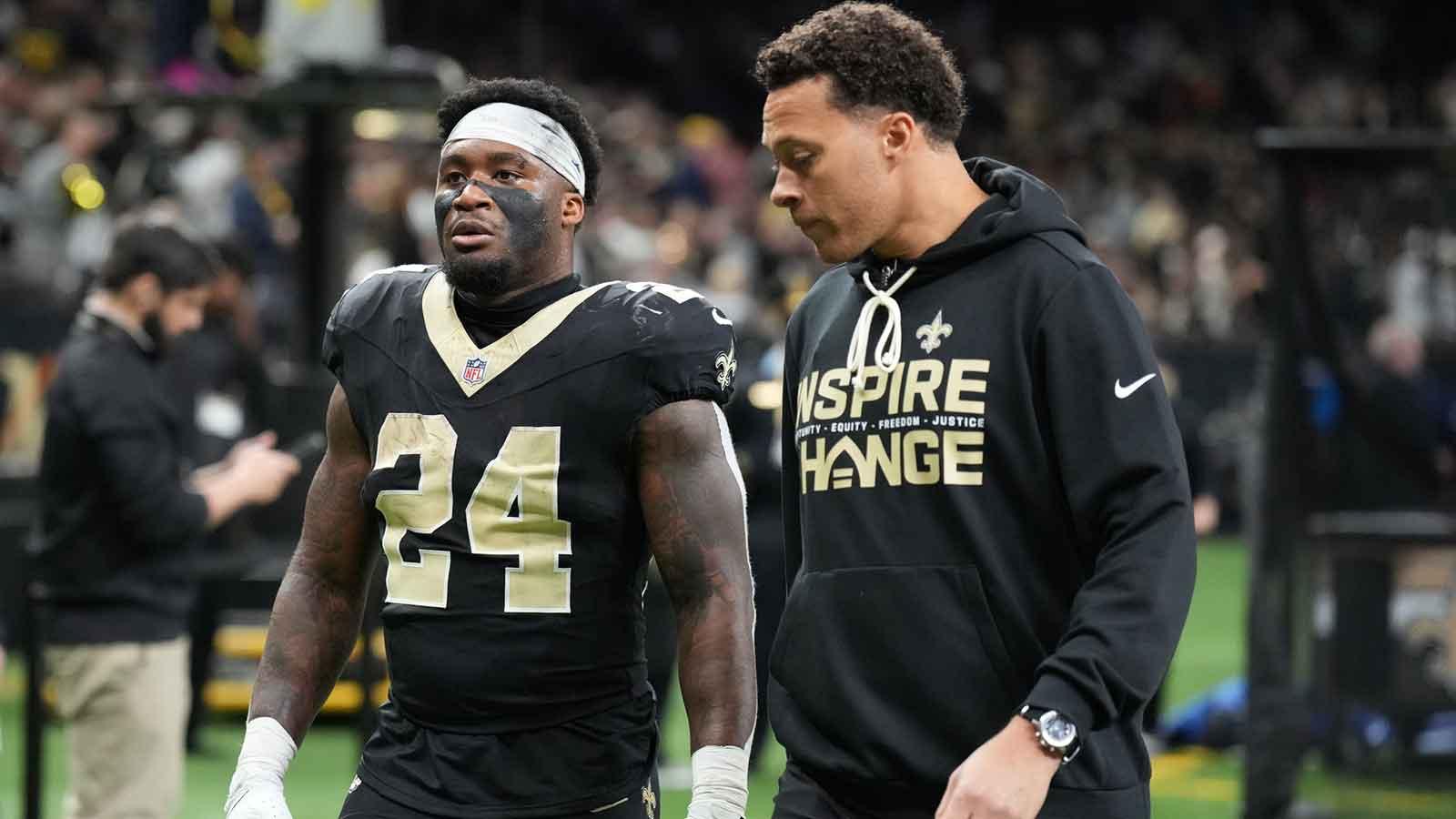 New Orleans Saints running back Devin Neal (24) is walked off of the field after an injury during the second quarter against the Carolina Panthers at Caesars Superdome