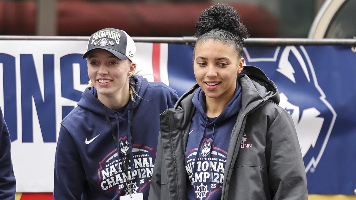UConn women's basketball student-athlete Paige Bueckers and UConn student-athlete Azzi Fudd walk onto the stage during the Final Four Champions victory parade and rally outside of the XL Center in Hartford, CT.