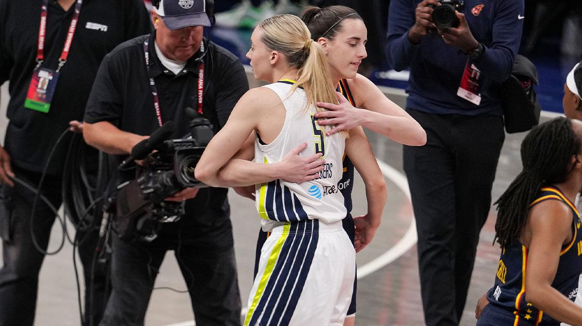 Fever guard Caitlin Clark and Wings' Paige Bueckers hugging