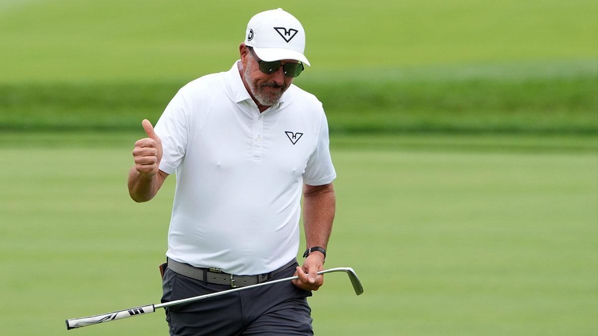 Phil Mickelson of Team HyFlyers GC reacts to the cheers of his fans as he walks up to the fourth green during the LIV Golf Michigan Team Championship semifinals at The Cardinal at St. John’s