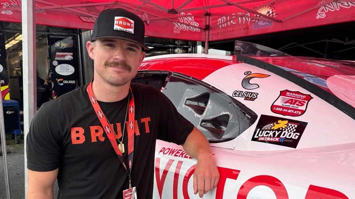 Mason Massey stands in front of his No. 14 car featuring the Lucky Dog on Track logo prior to the Xfinity Series race at Pocono Raceway, 2024.