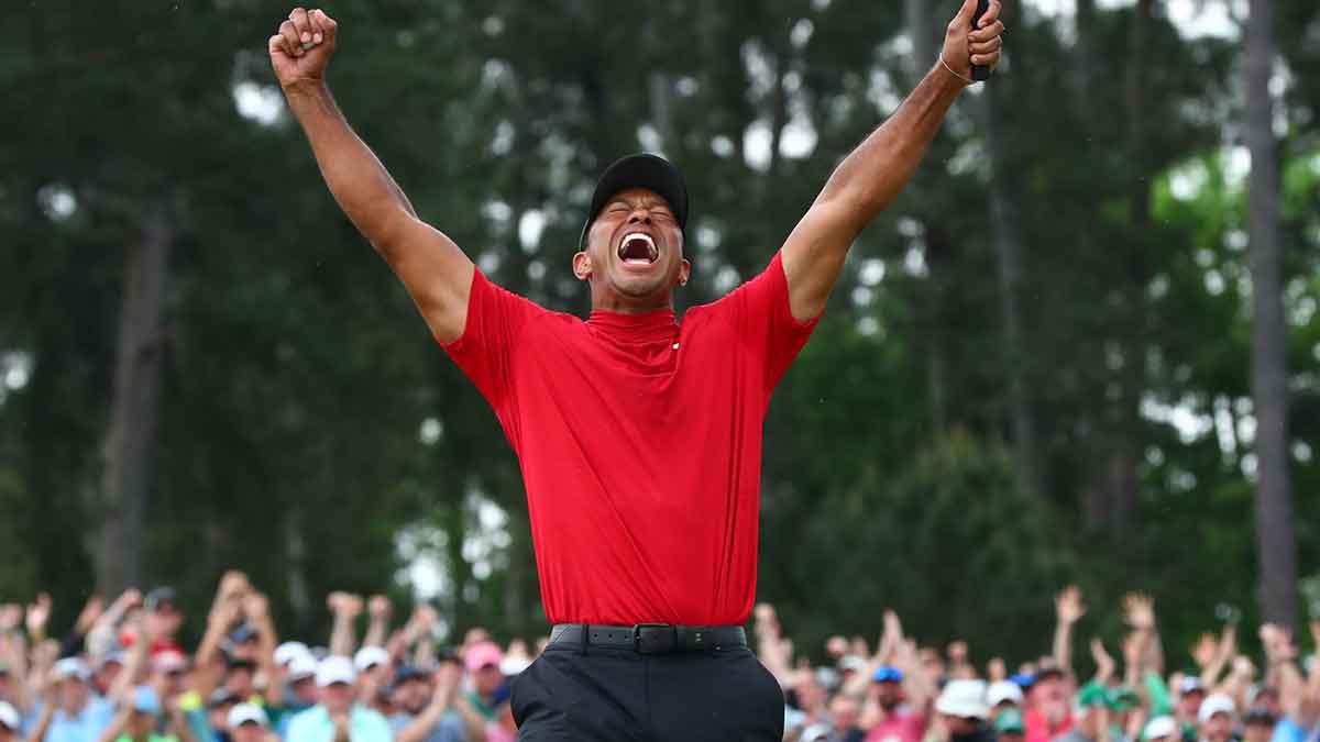 Tiger Woods celebrates after making a putt on the 18th green to win The Masters golf tournament at Augusta National Golf Club on April 14, 2019.