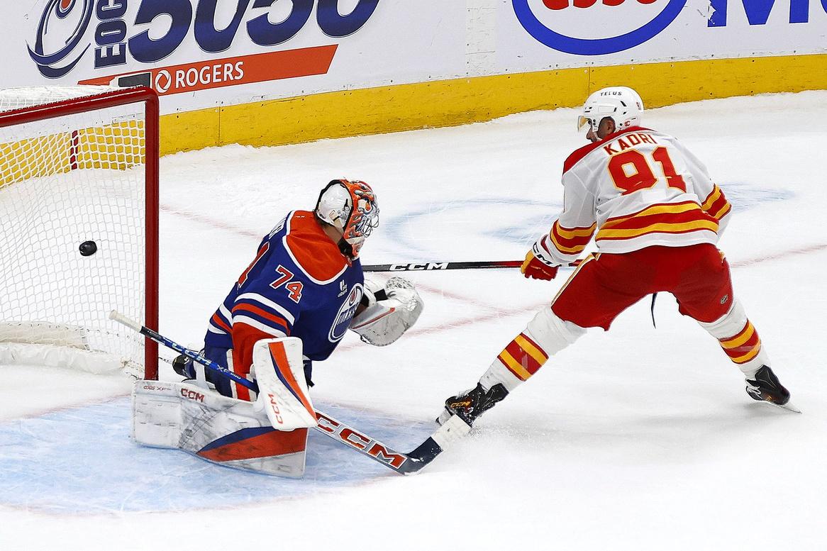 Calgary Flames forward Name Kadri (91) scores the game winning goal against Edmonton Oilers goaltender Stuart Skinner (74) during the shoot-out at Rogers Place.
