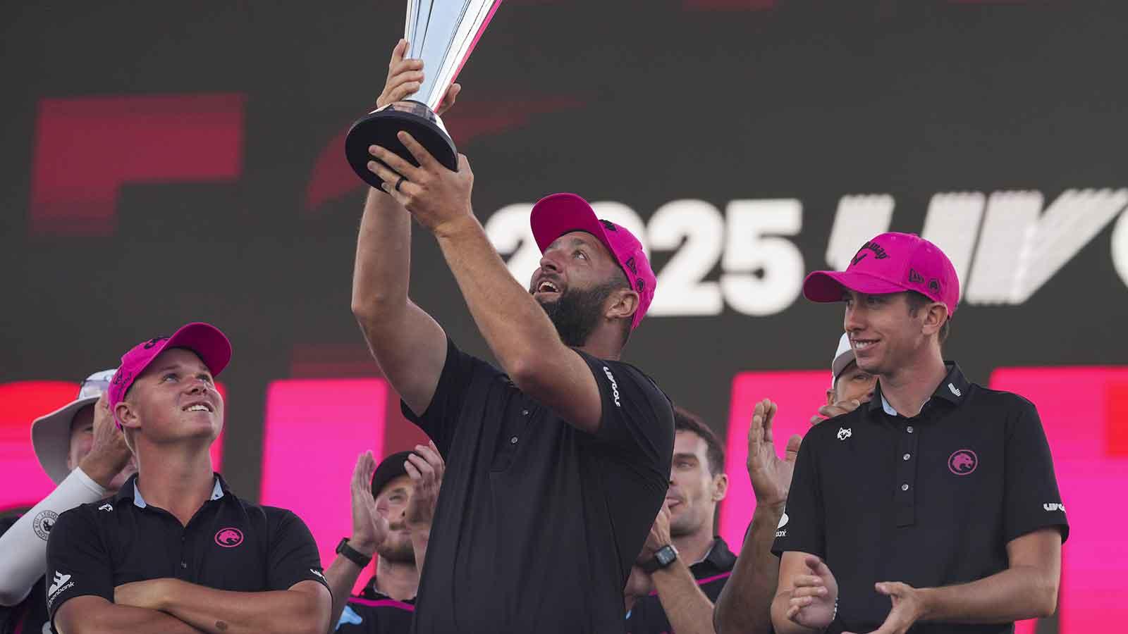 Jon Rahm and teammates of Legion XIII celebrate with the trophy after the finals of the LIV Golf Michigan Team Championship at The Cardinal at Saint John's Resort.