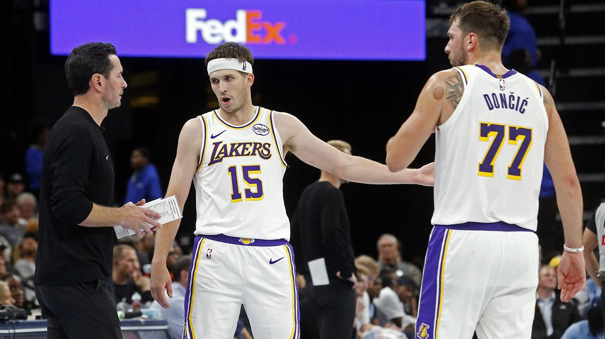 Lakers head coach JJ Redick talks with guard Austin Reaves (15) and guard Luka Doncic (77) during the fourth quarter against the Memphis Grizzlies at FedExForum