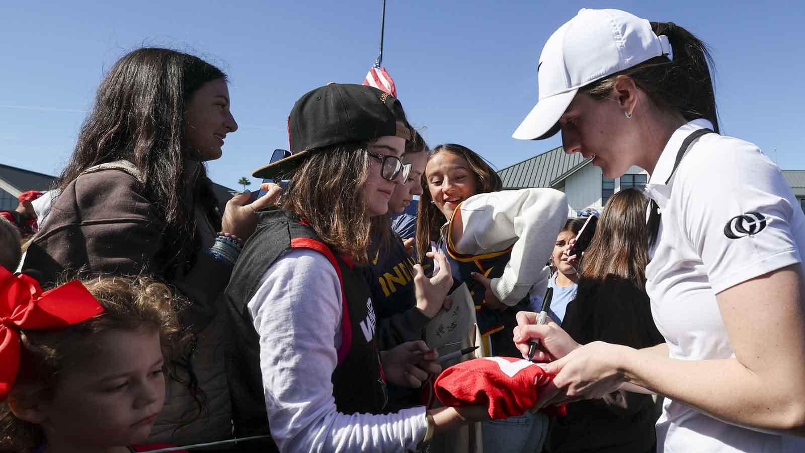 Nov 12, 2025; Belleair, Florida, USA; Indiana Fever guard Caitlin Clark (22) signs autographs for fans after the Annika Pro-Am golf tournament at Pelican Golf Club. Mandatory Credit: Nathan Ray Seebeck-Imagn Images