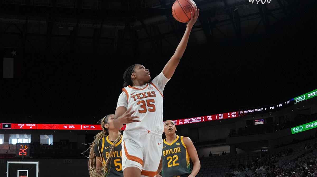 Texas Longhorns forward Madison Booker (35) scores a layup ahead of Baylor Bears forward Darianna Littlepage-Buggs (5) during the first half.