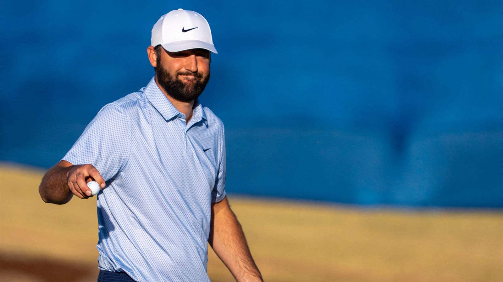 Scottie Scheffler gestures to the crowd after his final putt on 18 of the Pete Dye Stadium Course to win The American Express